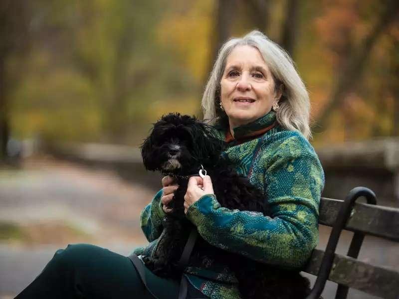 Mary Gordon photo on a park bench with her dog