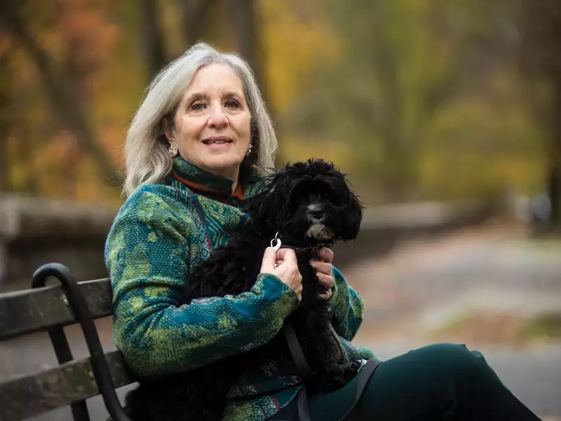 Mary Gordon photo on a park bench with her dog